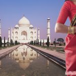 Indian woman in traditional clothing near the Taj Mahal